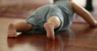 © Marco - Back of little baby infant on hardwood floor at home