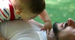 © Marco - Baby infant boy on top of father chest in outdoors setting touching dad neck candid authentic relationship