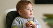 © Marco - Cute baby infant eating piece of apple fruit
