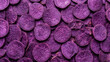 © Andika - Pile of dried purple sweet potato slices, scattered full frame texture in deep purple