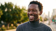 © ADDICTIVE STOCK - Smiling man outdoors in city during golden hour