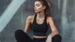 © JosPatricio - Fit young woman sitting on the floor of a modern gym wearing sportswear after training. Healthy lifestyle, fitness, strength, wellness, and motivation concept with natural light.