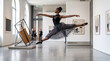 © rasdiana - Graceful female ballerina jumping in the air performing a split pose inside a modern minimal art gallery studio.