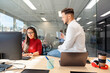 © Nunez Image SL/Stocksy - Coworkers collaborating and laughing in modern office