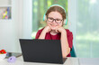 © Volodymyr - Class student listens with headset. Class learner studies with computer. Happy child enjoys class online. Young kid follows class lesson.