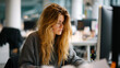 © Gold - Young woman focused on computer screen in office, candid close up, soft natural light, authentic lifestyle