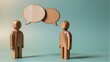 © joeycheung - Two wooden figures converse, speech bubbles above their heads.