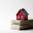 © Firadoaw - red house on stack of dollar bills property wealth concept