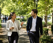 © Petr - Business Colleagues Walking And Talking In Green Park During Lunch Break