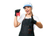 © luismolinero - Butcher woman wearing an apron and serving fresh cut meat over isolated chroma key background with thumbs up because something good has happened