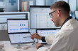© Andrey Popov - Man Uses Dual Touchscreen Laptop For Healthcare Billing