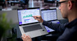 © Andrey Popov - Young Man Uses Dual Touchscreen Laptops For Strategic Supplier Evaluation