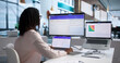 © Andrey Popov - Woman Analyzing Digital Data On Dual Screens