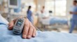 © Ceri - Patient with pulse oximeter in hospital bed.