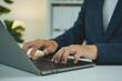 © Custard Pixel - Business laptop typing closeup businessman working on keyboard for online productivity digital workflow remote office communication data entry and professional technology tasks.