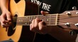 © Fatimah - Close-up of hands playing guitar.