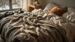 © Sona - A cozy bedroom scene with unmade bed, blankets, pillows, and natural light coming through a window.