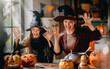 © Konstantin Yuganov - Happy Family Halloween Celebration with Costumes and Pumpkins