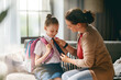 © Konstantin Yuganov - Mother Helping Daughter Get Ready for School Morning Routine
