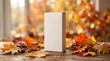 © Game - Autumn product podium mockup with blank white box on table, colorful fall leaves and warm sunlight bokeh