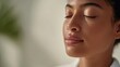 © Nart - A woman with radiant, glowing skin enjoys a peaceful spa moment in soft, diffused light. The minimal composition highlights her beauty and luxurious lifestyle.