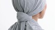 © vasyl pshyk - Woman with gray scarf tied at the back looking away from the camera in a simple setting