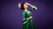 © NovaShots - Beautiful woman wearing a green vintage gown and pearls on a purple background.
