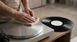 © Stitch - Hands using a soft cloth to clean a silver turntable next to a vinyl record