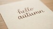 © velikiyzayats - Hello Autumn handwritten typography note on textured paper for seasonal greeting cards and social media posts