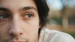 © velikiyzayats - Close-up portrait of a young adult Caucasian man with thoughtful expression and hazel eyes, looking away in deep contemplation