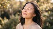 © MdShariful - Young woman enjoying warm sunlight outdoors. Serene female model feeling golden rays on face in nature.