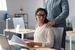 © Prostock-studio - Worried Hispanic Woman In Office Looking At Documents While Receiving Support From Male Colleague With Hand On Shoulder, Working Together In Professional Environment, Business Concept.