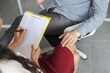 © Prostock-studio - Focused Female Therapist Taking Notes While Consulting With Unrecognizable Male Patient In Office Environment. Professional Consultation In Healthcare Setting, Emotional Support And Guidance Provided.