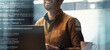 © Prostock-studio - Cheerful Young Caucasian Man Smiling While Working On Laptop In Stylish Office Environment. Focused On His Work As He Engages With Technology, Representing A Business Concept.