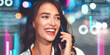 © Prostock-studio - Happy Young Caucasian Woman Speaking On Phone, Sitting Outside In Urban Environment With Blurred City Lights, Engaged In Conversation At Night. Business Concept.