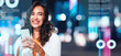 © Prostock-studio - Smiling Young Caucasian Woman Holding Smartphone In Urban Night Setting, Radiating Joy And Confidence, Engaging With Mobile Device While Enjoying City Vibe, Business Concept.