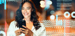 © Prostock-studio - Smiling Young Woman With Brown Hair Using Smartphone While Standing At Urban Environment During Night. Engaged In Chatting Or Browsing On Mobile Device, Enjoying Technology Concept.