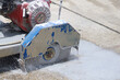 © Bowonpat - A walk-behind concrete cutter machine, concrete cutter blade spinning with water.