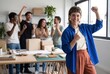 © Asier - Happy business team celebrating a successful project, feeling joy and achievement
