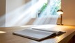 © Rasis - Open notebook on wooden desk with sunlight and lamp