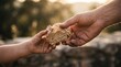 © Luz - A close-up shot of an adult hand passing a piece of rustic bread to a child, symbolizing charity, kindness, and nourishment.