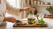 © starush - Hands preparing an herbal evening tea ritual at home