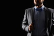 © Pixel-Shot - Handsome man in grey suit with bow tie on dark background
