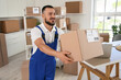 © Pixel-Shot - Male worker with parcel box in warehouse