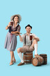 © Pixel-Shot - Happy mature waiters in traditional German clothes with barrels, mugs of beer and snacks sitting on blue background