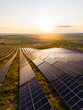 © DSMT - Solar panels collect sunlight at sunset on a field, showing renewable energy in action on a bright evening