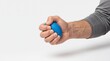 © puja - Close-up of a hand squeezing a blue egg-shaped stress ball for physical therapy, grip strengthening, and anxiety relief on white