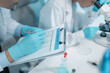 © PHOTO4U - Biomedical scientists perform laboratory experiments using microscopes, laboratory glassware, and biological samples while recording results to support medical research, diagnostics and biotechnology.