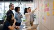 © Fikri Haikal - Coworkers Brainstorming Together in Modern Office