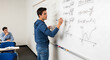 © Kalpona - Young male student writing complex math equations on whiteboard in classroom